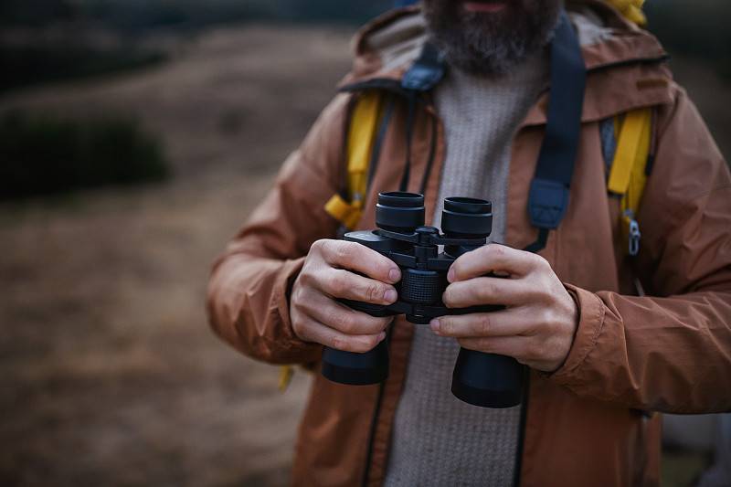 Binoculars on hands