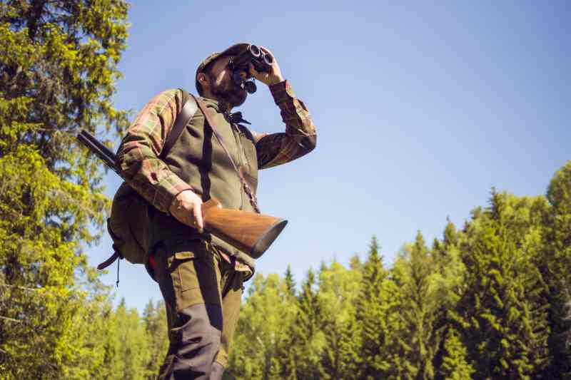 Hunter using waterproof binoculars