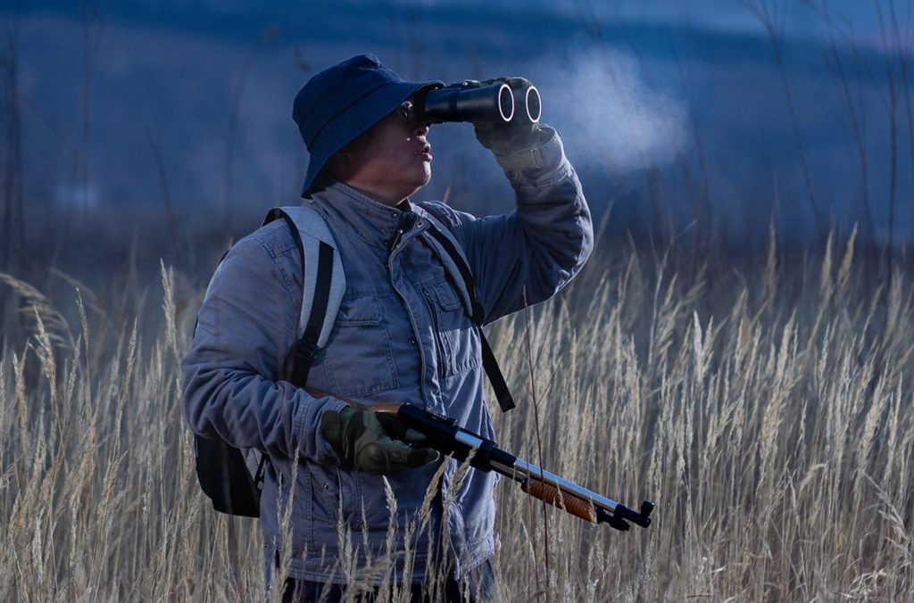 Hunter holding a Nikon binocular