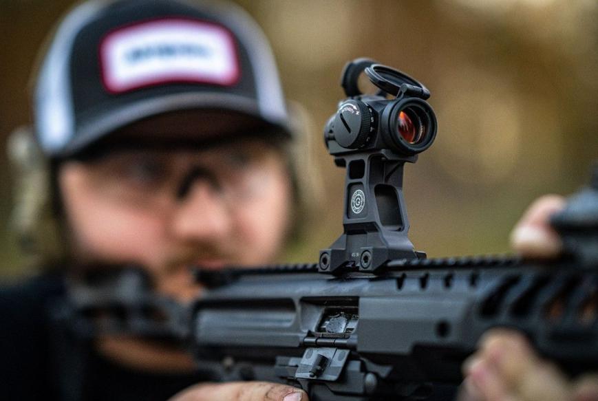 A red dot sight mounted in a high position