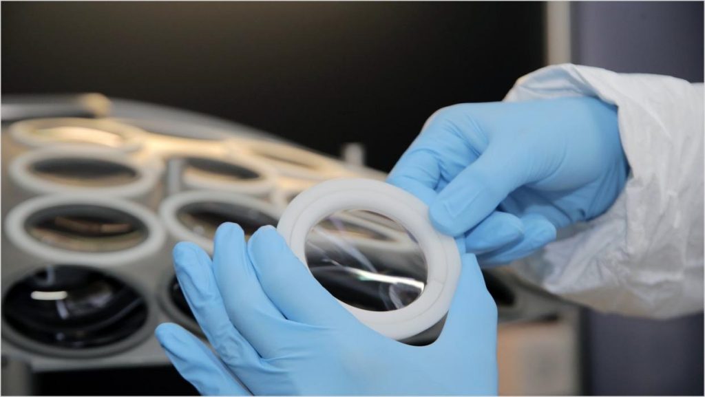 Actual shot of loading and inspecting optical lenses before coating